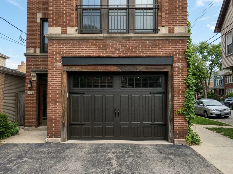 After: New Amarr steel carriage house door with woodgrain finish in Rogers Park Chicago